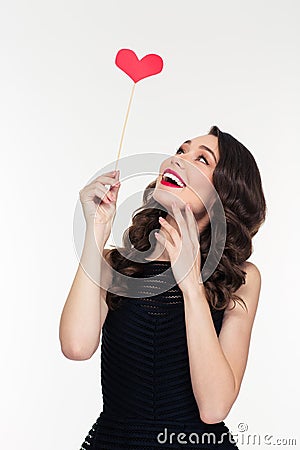 Portrait of cheerful retro styled young woman with heart booth Stock Photo