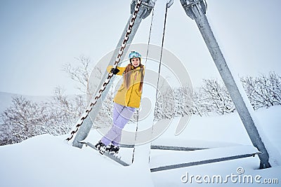 Portrait of cheerful skier girl in yellow jacket Stock Photo