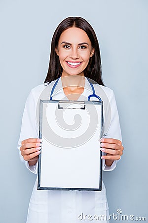 Portrait of cheerful smiling doctor showing empty folder Stock Photo