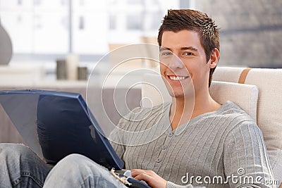Portrait of cheerful young man using computer Stock Photo