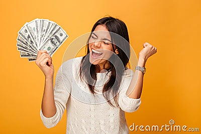 Portrait of a cheerful young woman holding money Stock Photo