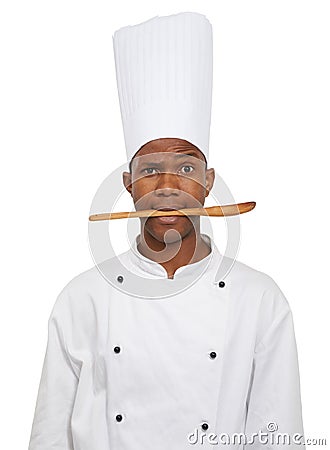 Portrait, chef and black man with spoon in mouth isolated on white studio background. Person, kitchen utensil and Stock Photo