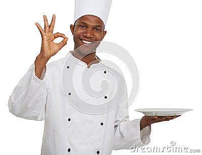 Portrait, chef and ok sign with plate presentation in studio isolated on white background. Smile, cooking or okay hand Stock Photo