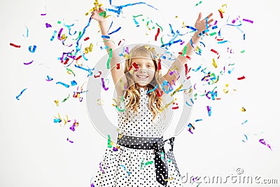 Portrait of a child throws up multi-colored tinsel and confetti Stock Photo