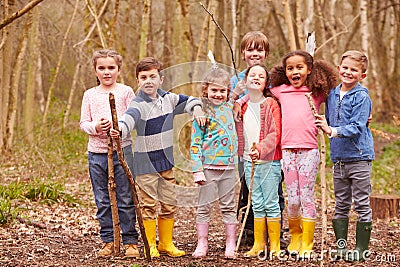 Portrait Of Children Playing Adventure Game In Forest Stock Photo