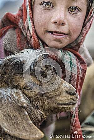 Portrait of children who wake up in the morning to milk sheep Editorial Stock Photo