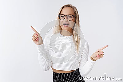 Portrait of chill unbothered attractive businesswoman with blond hair glasses and cropped sweater dancing pointing Stock Photo