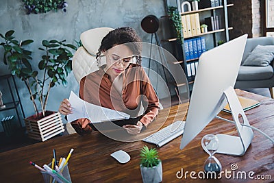 Portrait of clever company accountant lady sitting chair read clipboard documents desk loft office indoors Stock Photo