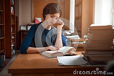 Portrait of clever student in university library. Stock Photo