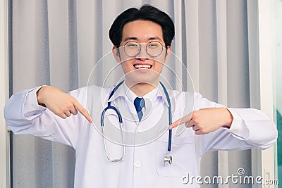 Doctor man smiling and stethoscope neck strap show finger thumb up Stock Photo