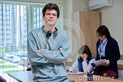 Portrait of college student guy looking at camera inside classroom Stock Photo