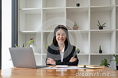 Portrait confidence asian business woman looking on camera sitting at work desk in office. Stock Photo