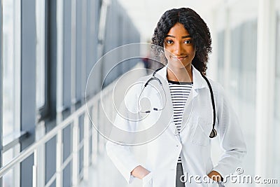 Portrait confident African American female doctor medical professional writing patient notes isolated on hospital clinic hallway Stock Photo