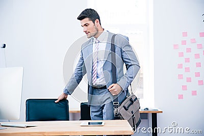 Portrait of a confident businessman with bag Stock Photo