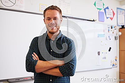 Portrait of confident Caucasian male teacher in classroom Stock Photo