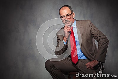 Portrait of confident entrepreneur wearing glasses and thinking Stock Photo