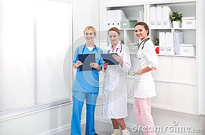 Portrait of confident happy group of doctors standing at the medical office Stock Photo