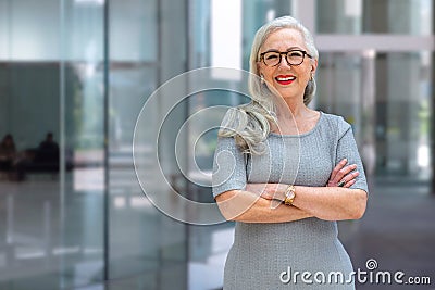 Portrait of a confident mature business person standing outside office workspace, bank, financial institution Stock Photo