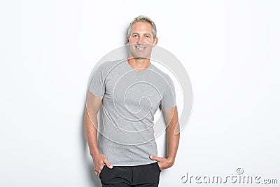 Portrait of confident mature man standing on white background Stock Photo