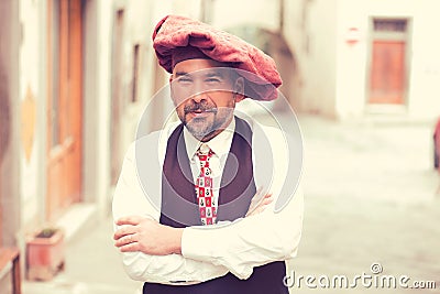 Portrait of a confident middle aged man standing outdoors on a street of an old village Stock Photo