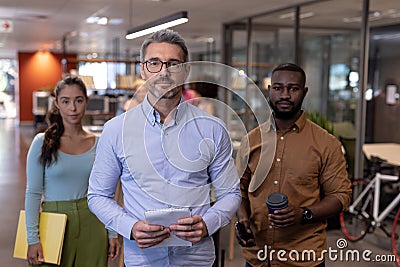 Portrait of confident multiracial business advisors standing together at modern workplace Stock Photo