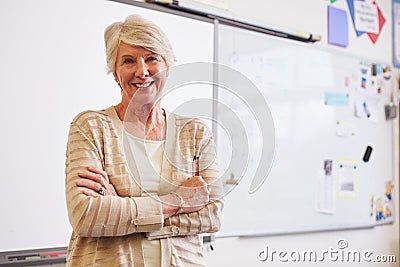 Portrait of confident senior female teacher in classroom Stock Photo