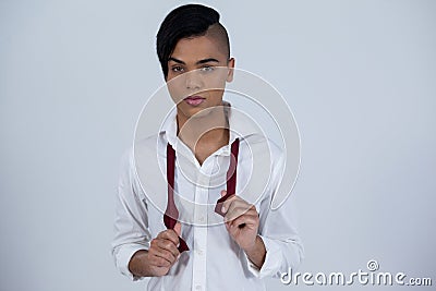 Portrait of confident transgender female holding red tie Stock Photo