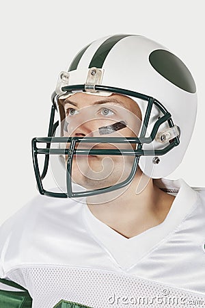 Portrait of confident young man wearing football uniform against gray background Stock Photo