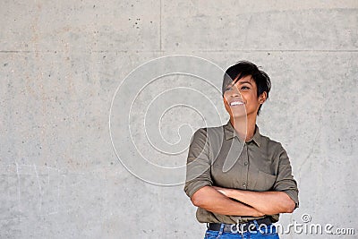 Confident young modern black woman standing with her arms crossed Stock Photo