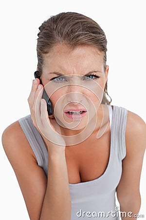 Portrait of a confused woman making a phone call Stock Photo