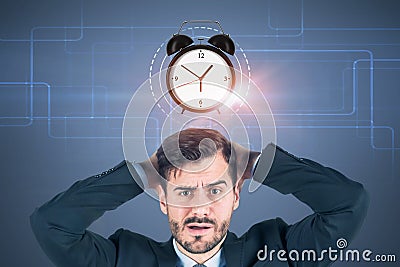 Confused businessman, alarm clock Stock Photo