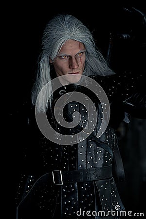 Portrait of cosplayer in image of character Geralt of Rivia from the game or film The Witcher Editorial Stock Photo