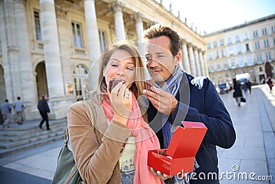 Portrait of couple enjoying eating pastries Stock Photo