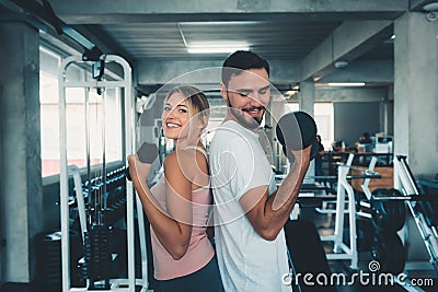 Portrait of Couple Love in Fitness Training With Dumbbell Equipment., Young Couple Caucasian are Working Out and Training Together Stock Photo