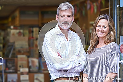 Portrait Of Couple Who Own Bookshop Outside Store Stock Photo
