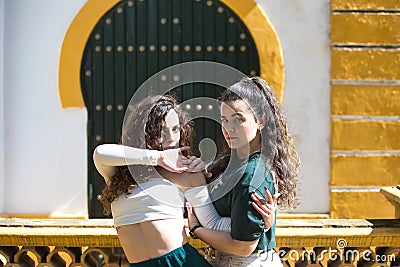Portrait of a couple of young women dancing to different types of Latin music and dance. The two girls do different postures Stock Photo
