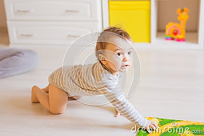 Portrait of crawling funny baby boy indoors at home Stock Photo