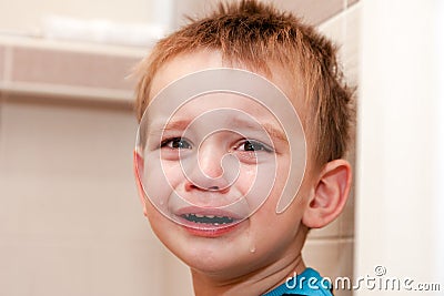 Portrait Of Crying Baby Boy In Home Stock Photo