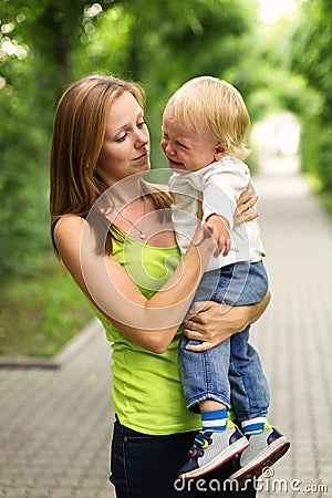 Portrait of a crying little boy who is being held Stock Photo