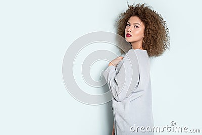 Portrait of curly-haired young woman with hairstyle and make-up. Stock Photo