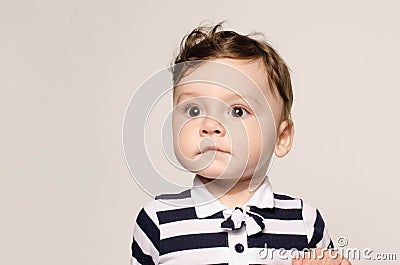 Portrait of a cute baby boy looking away surprised with his big eyes. Stock Photo
