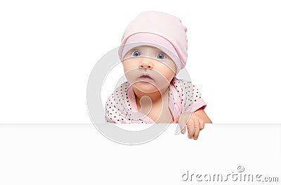 Portrait of cute curious baby girl, peeking from behind a banner Stock Photo