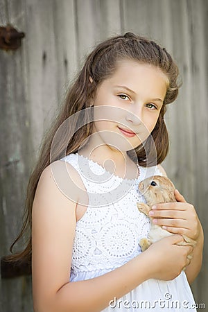 Portrait of a cute girl with adorable rabbit Stock Photo