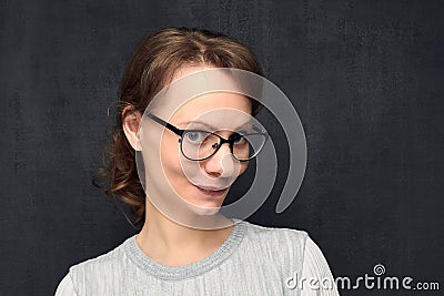 Portrait of cute and intrigued young woman with glasses Stock Photo