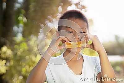 Portrait of cute kid in imagines some yummy food with eyes. Stock Photo