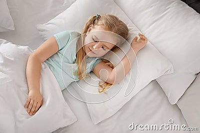 Portrait of cute little girl sleeping in large bed Stock Photo