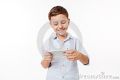 Portrait of a cute little kid playing games on smartphone Stock Photo