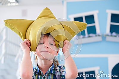 Portrait of a cute little school boy with yellow pillow crown Stock Photo