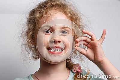 Portrait of cute six years girl losing her first milk tooth Stock Photo