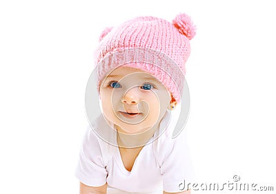 Portrait cute smiling baby in knitted pink hat on white Stock Photo